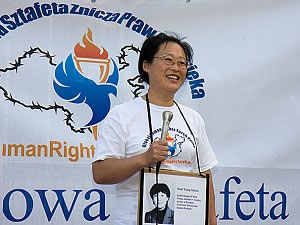 Джанг Чиян (Zhang Qian) говори по време на Глобалната щафета на огъня за човешки права пред китайското посолство във Варшава, Полша