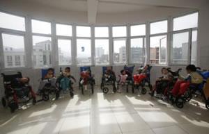 Деца, страдащи от церебрална парализа, чакат за следобедна закуска в Центъра за сираци и деца с увреждания в Шининг